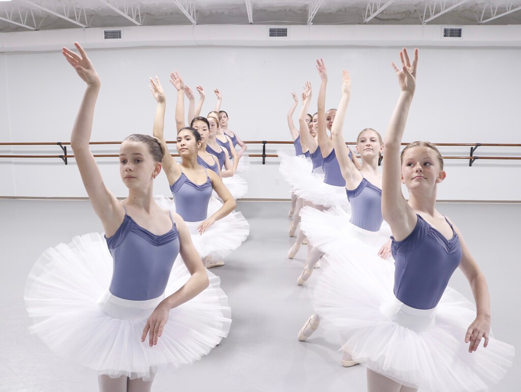 Brevard Ballet Academy students in blue leotards and white tutus posing in the studio in Melbourne, Brevard County FL
