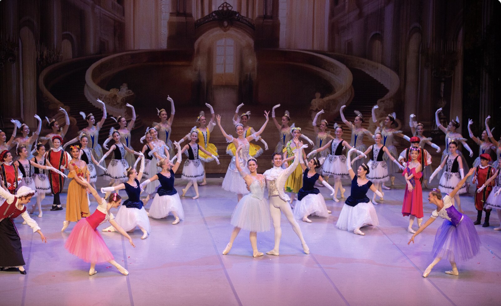 Full ensemble on stage with lead dancers center during a Brevard Ballet Youth Company production in Melbourne FL