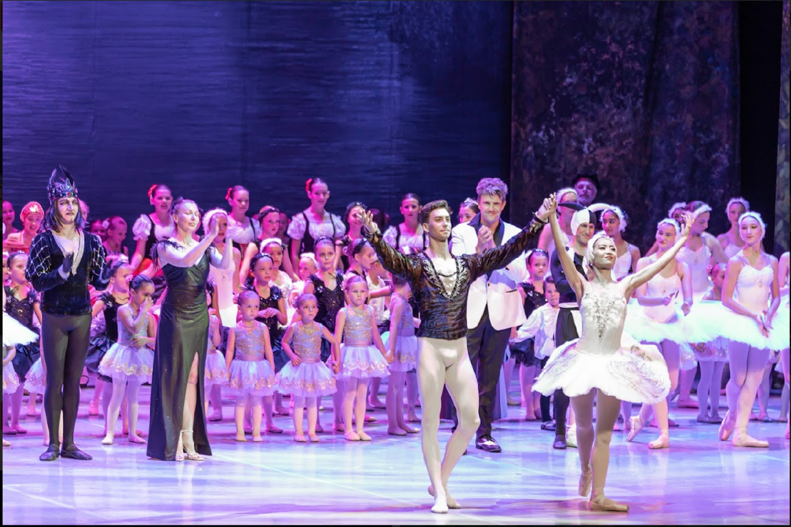 Swan Lake principal dancers taking curtain-call bows with the full cast at a Brevard Ballet Youth Company production in Melbourne FL