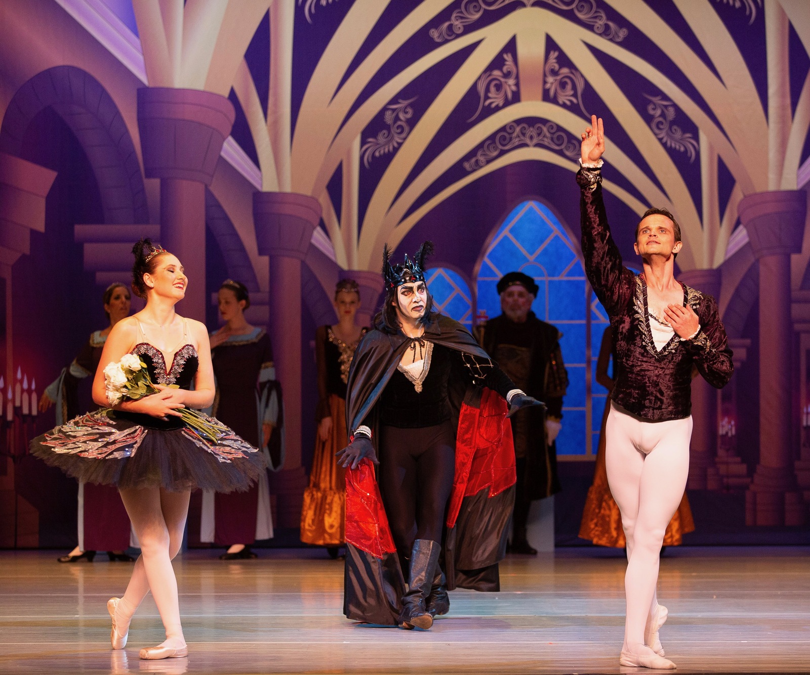 Odette, Prince Siegfried, and the sorcerer Rothbart in a Swan Lake scene performed by the Brevard Ballet Youth Company in Melbourne FL